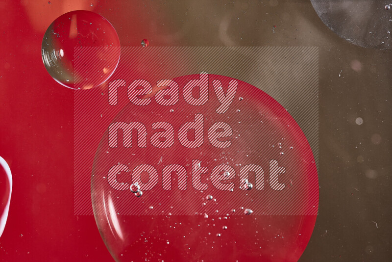 Close-ups of abstract oil bubbles on water surface in shades of red and brown