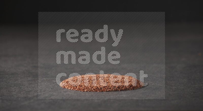 Garden cress seeds in a circle shape on a black flooring