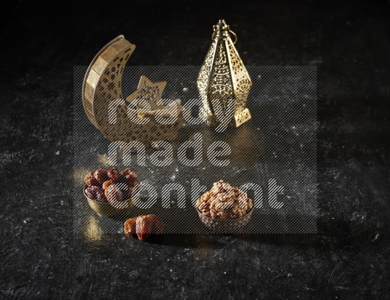 Dates in a metal bowl with walnuts beside golden lanterns in a dark setup