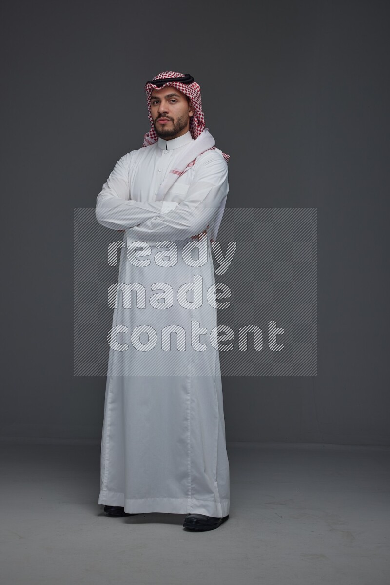 A Saudi man wearing Thobe and Shmagh standing in different poses eye level on a gray background
