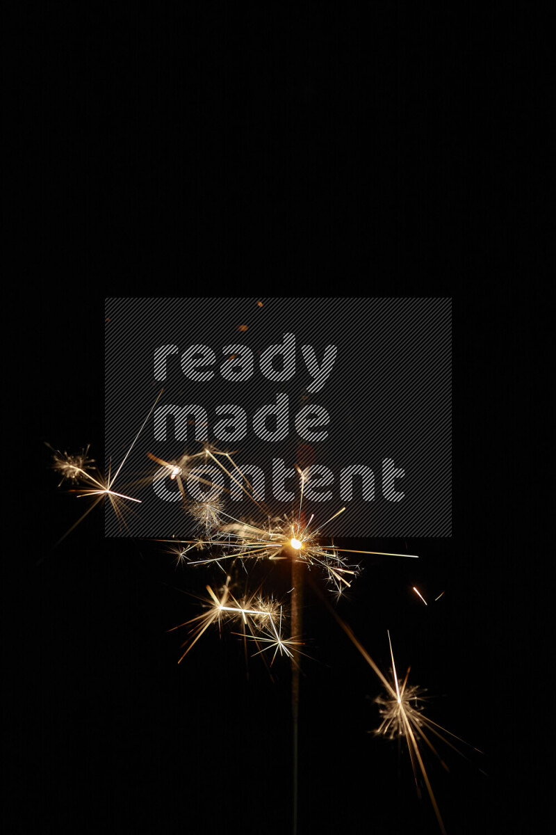 A close-up image of sparkler candle isolated on black background