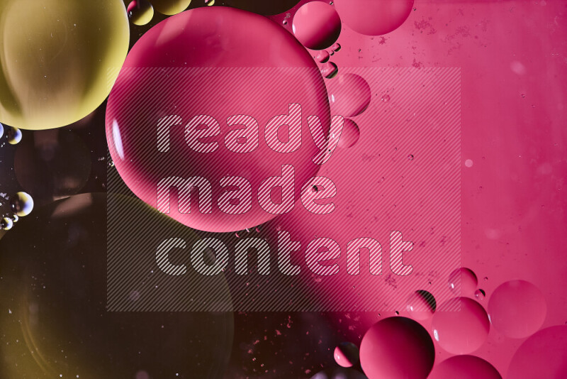 Close-ups of abstract oil bubbles on water surface in shades of yellow and pink