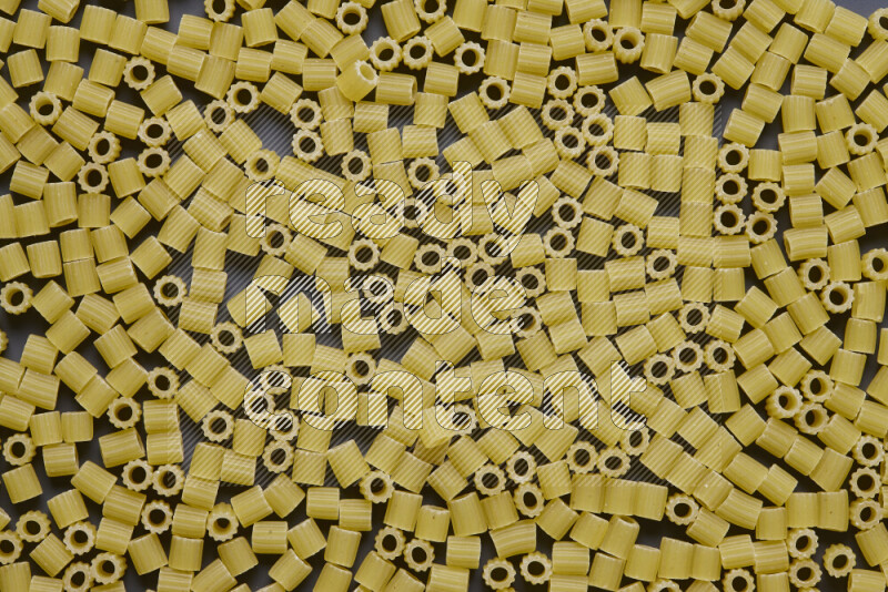 Small rings pasta on grey background