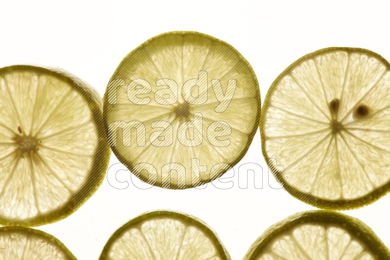 Lemon slices on illuminated white background