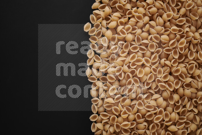 Different pasta types on black background