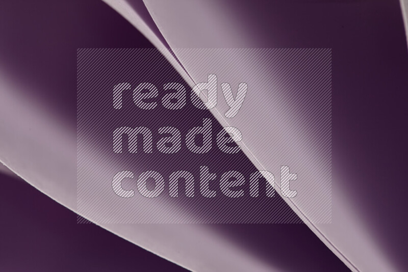 An abstract art showing purple paper sheets arranged in an overlapping curves