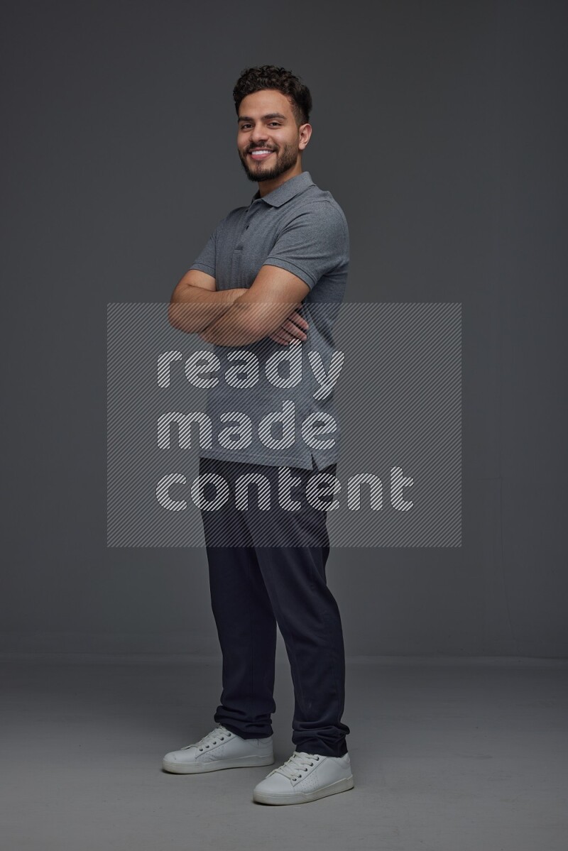 A man wearing casual making multi stand poses  eye level on a gray background