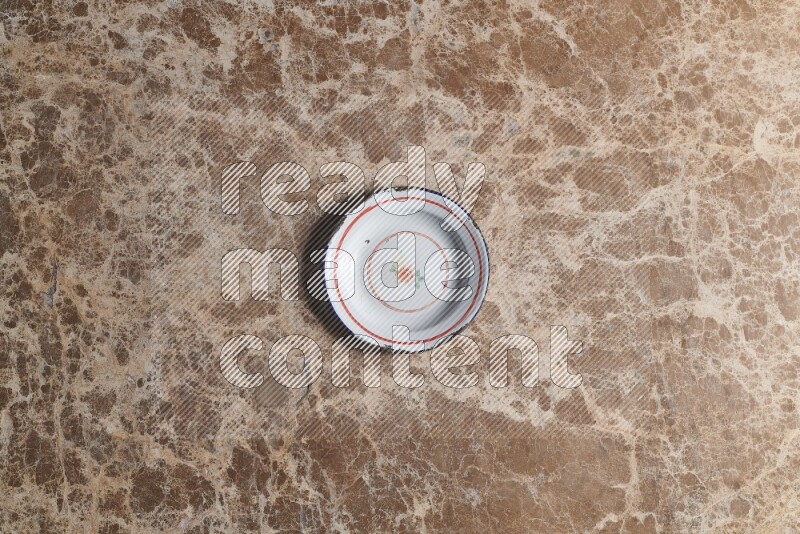 A vintage metal plate on beige marble background