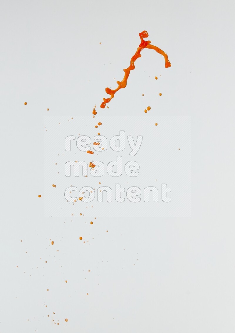 Orange liquid splash and drops on white background
