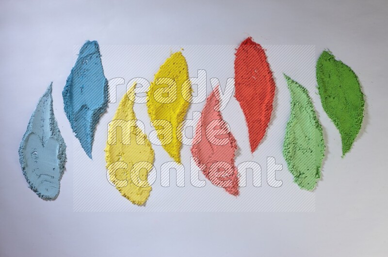 Multicolored powder smears on white background