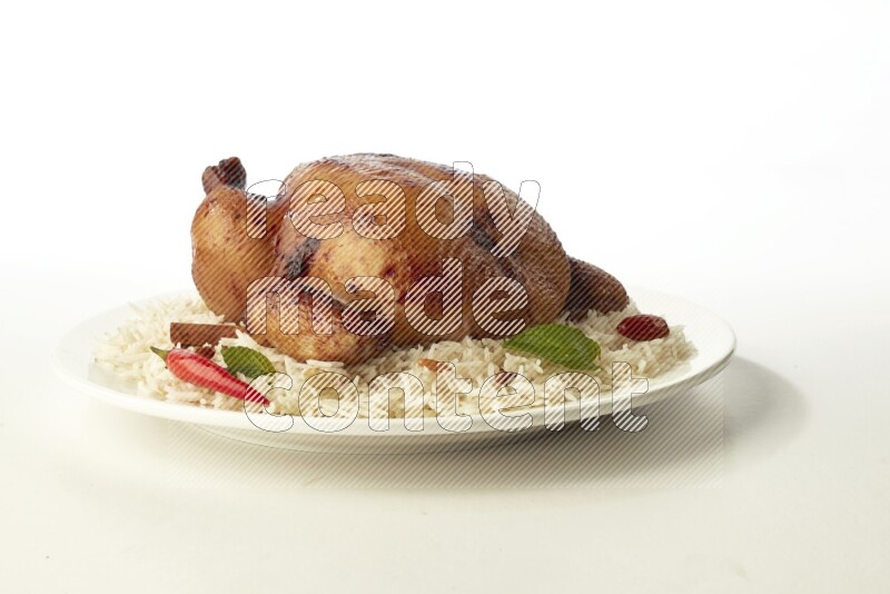 white  basmati Rice with  whole roasted chicken  on a white rounded plate direct on white background