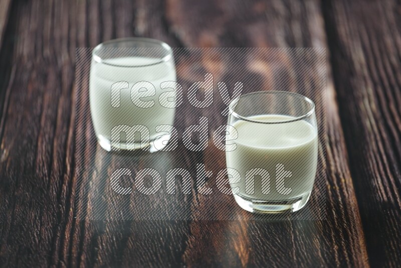 Cold drinks in a glass cup such as water, tamarind, qamar eldin, sobia, milk and hibiscus on wooden background