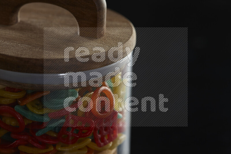 Snacks in a glass jar on black background
