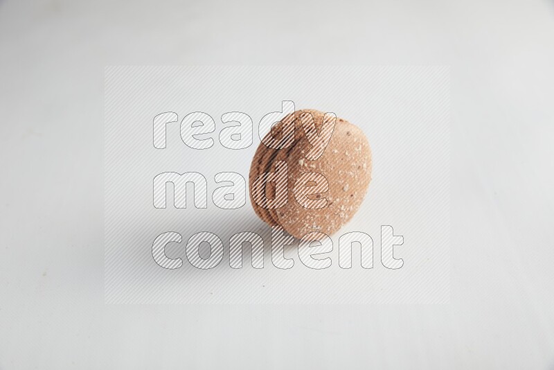45º Shot of Brown Hazelnuts macaron on white background