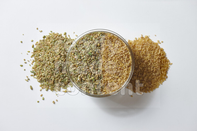 Coarse bulgur with freekeh on white background