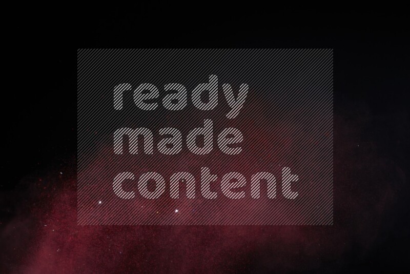 Red powder explosion on black background