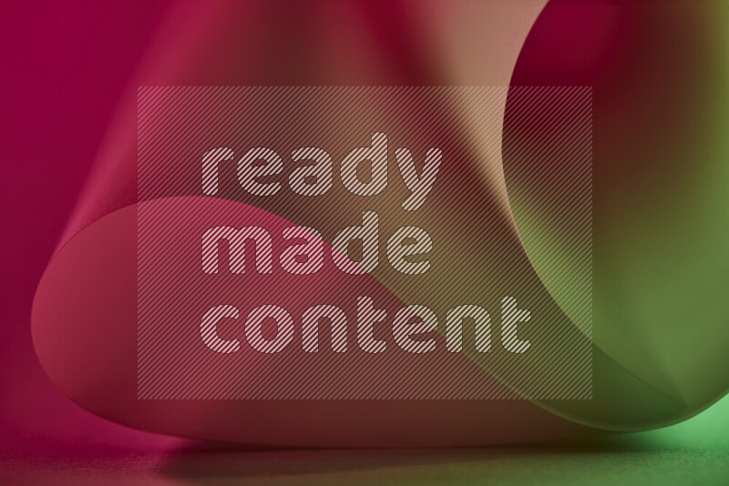 An abstract art piece displaying smooth curves in green and red gradients created by colored light