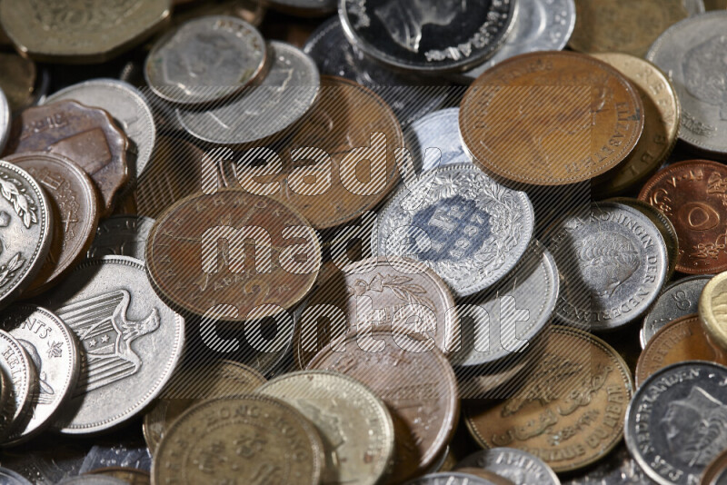 A close-ups of random old coins on black background