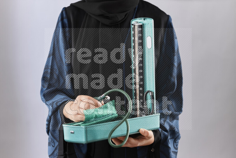 Female doctor wearing an abaya and medical attire in different positions