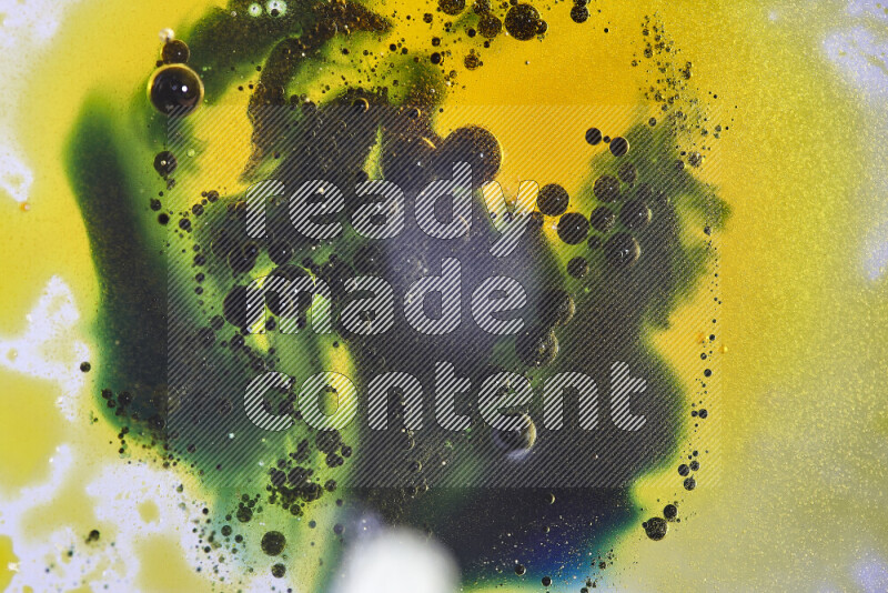 Close-ups of abstract yellow, blue and green watercolor drops on oil Surface on white background