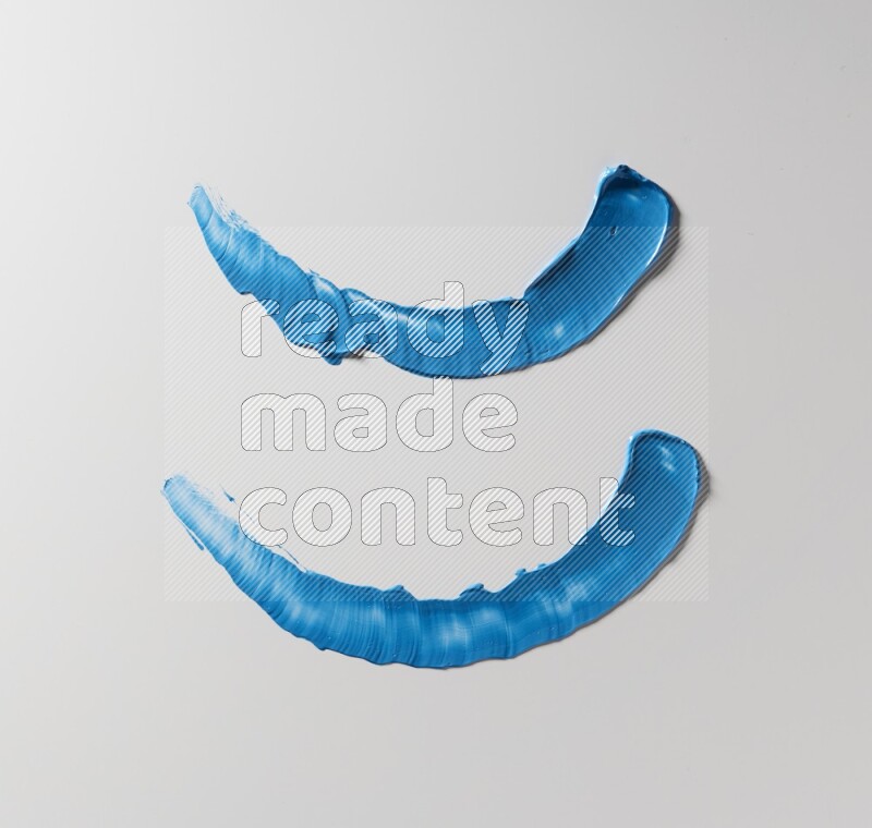 Blue curved painting knife strokes on white background