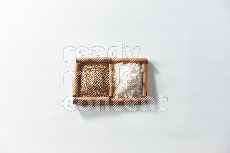 2 squares of cinnamon sticks full of mustard seeds and white salt on white flooring
