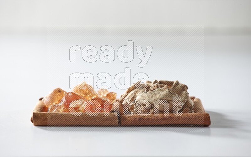 2 squares of cinnamon sticks full of dried ginger and gum arabic on white flooring