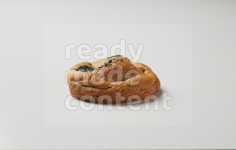 Hasawi cookie field with date and decorated by black seed and Anise grain on a white background