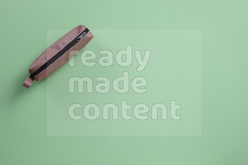 Different school supplies on green background