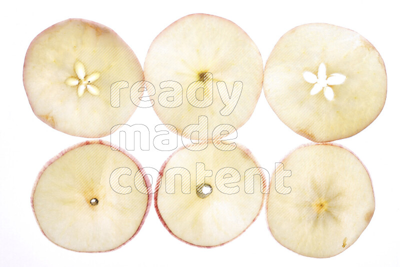 Apple slices on illuminated white background