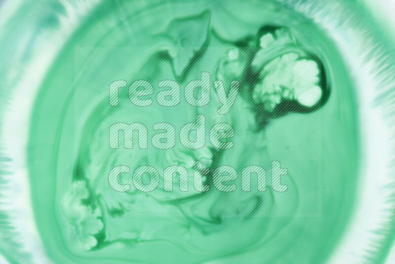 A close-up of abstract swirling patterns in green gradients