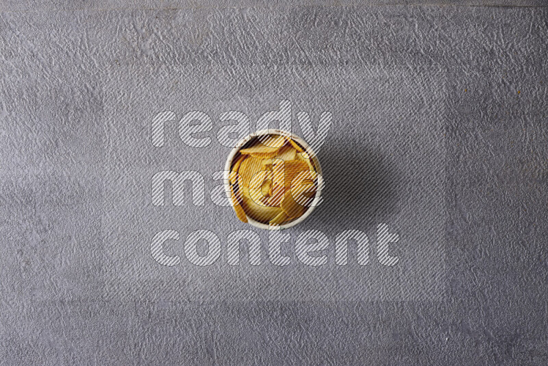 Assorted snacks in pottery bowls on grey background