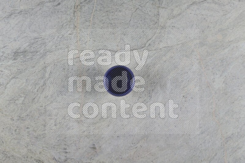 A multicolored pottery Cup on grey marble background