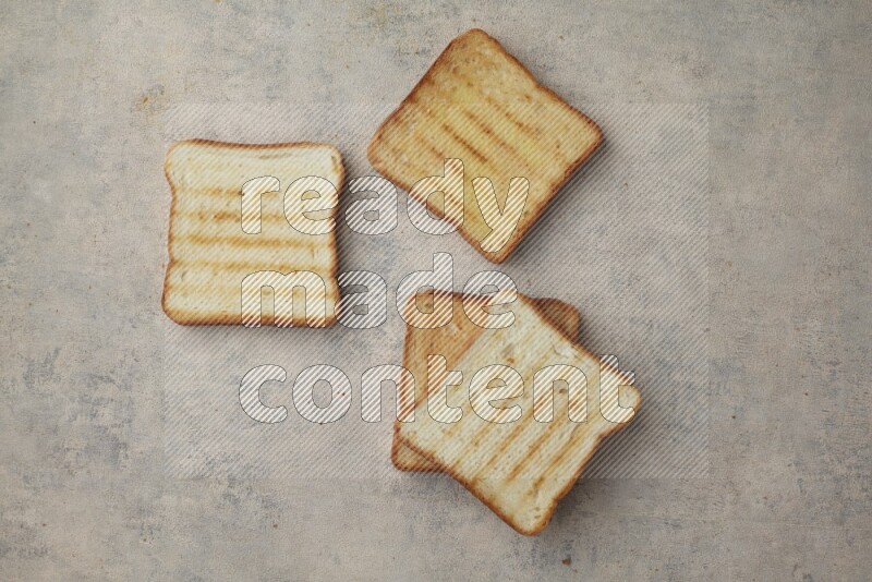 Toasted white Toast slices on a light blue textured background