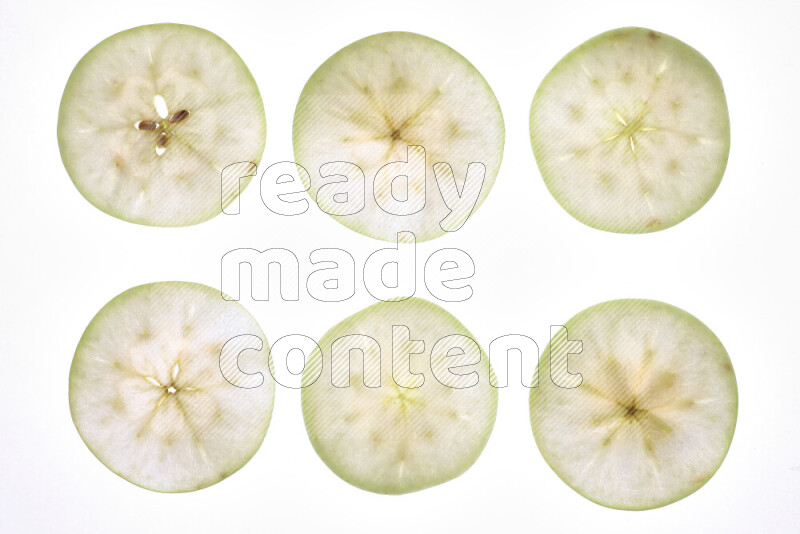 Apple slices on illuminated white background