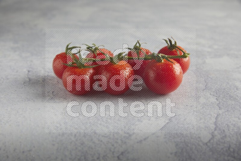 Red cherry tomato vein on a light grey textured background 45 degree