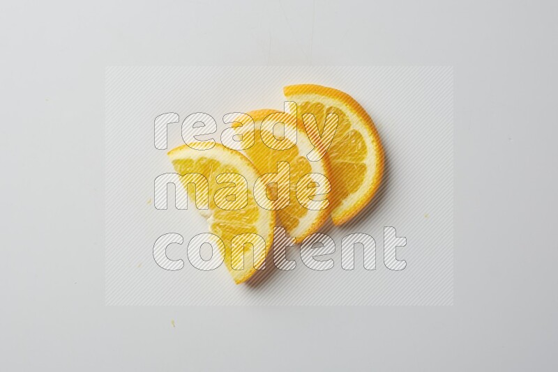 Three halves of an orange slices on white background