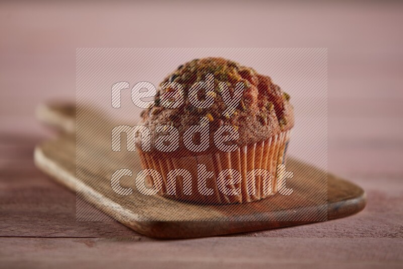 Pistachio cupcake on a wooden board