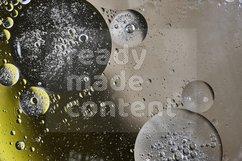 Close-ups of abstract oil bubbles on water surface in shades of brown, black and yellow