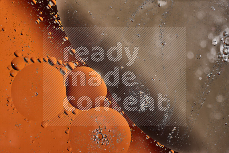 Close-ups of abstract oil bubbles on water surface in shades of orange and brown