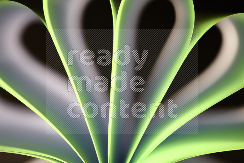 An abstract art piece displaying smooth curves in white and green gradients created by colored light