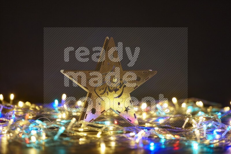 A traditional ramadan lantern surrounded by glowing fairy lights in a dark setup