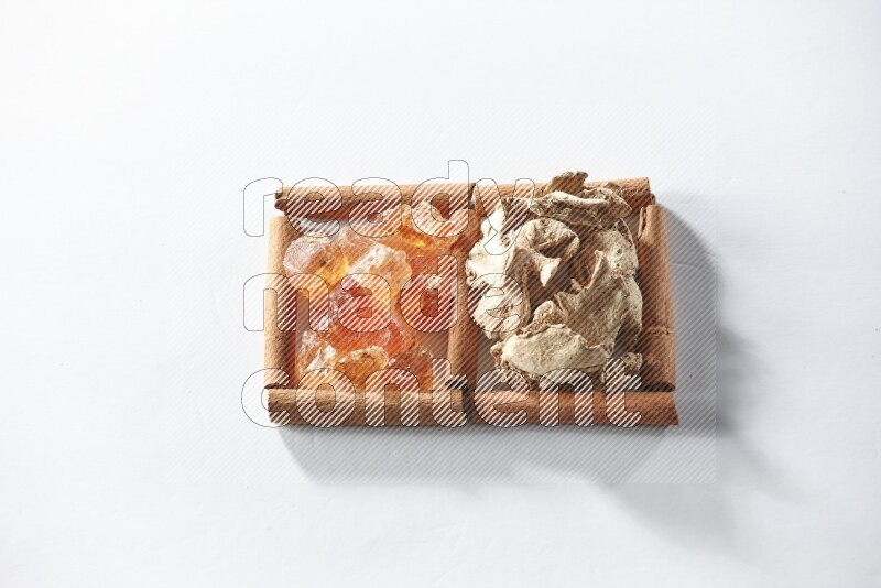 2 squares of cinnamon sticks full of dried ginger and gum arabic on white flooring