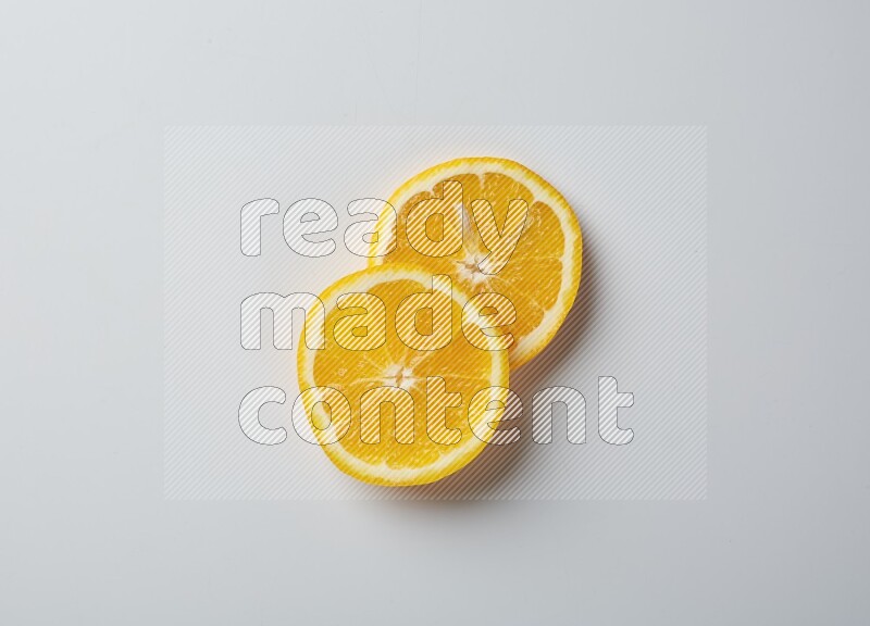 Two orange slices on white background