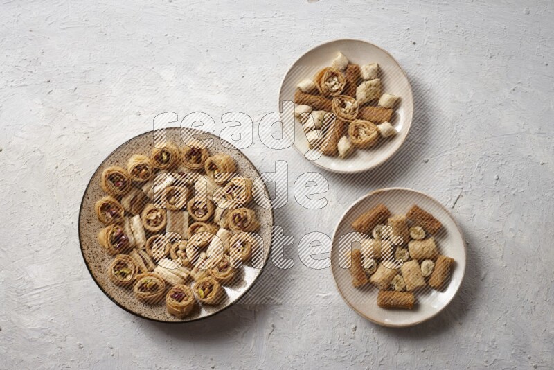 Oriental sweets in pottery plates in a light setup