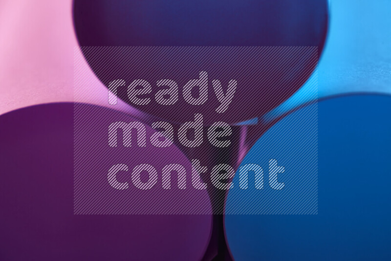 The image shows an abstract paper art with circular shapes in varying shades of blue and purple