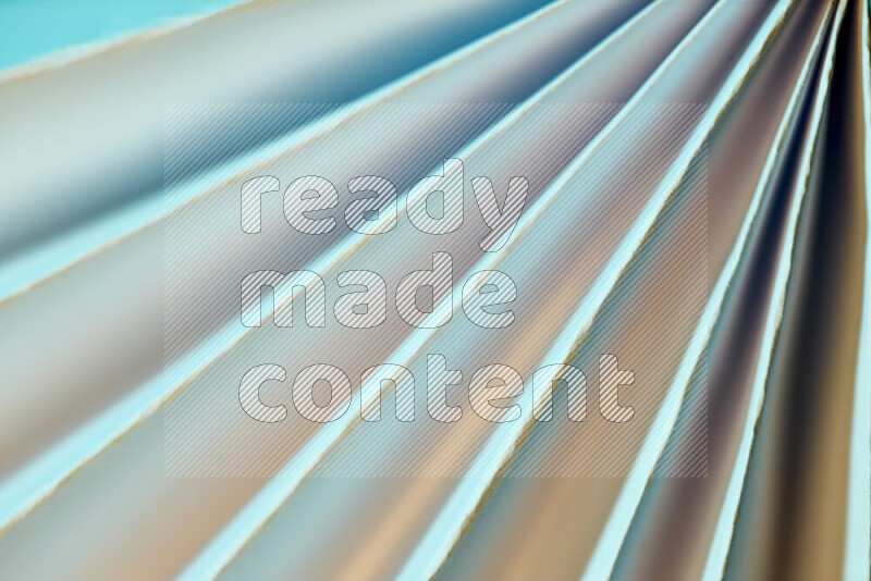 An image presenting an abstract paper pattern of lines in blue and gold tones