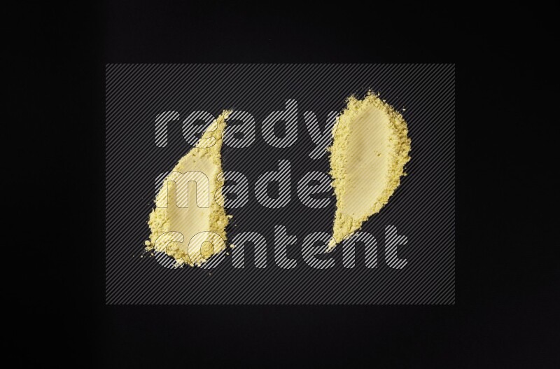 Yellow powder smears on black background