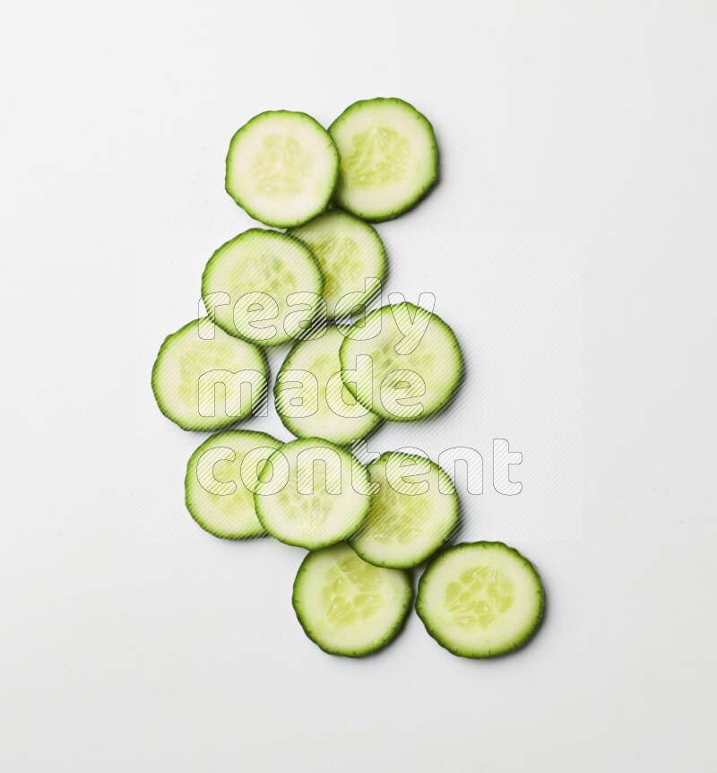Multiple cucumber slices on white background
