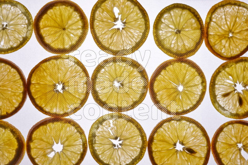 Orange slices on illuminated white background